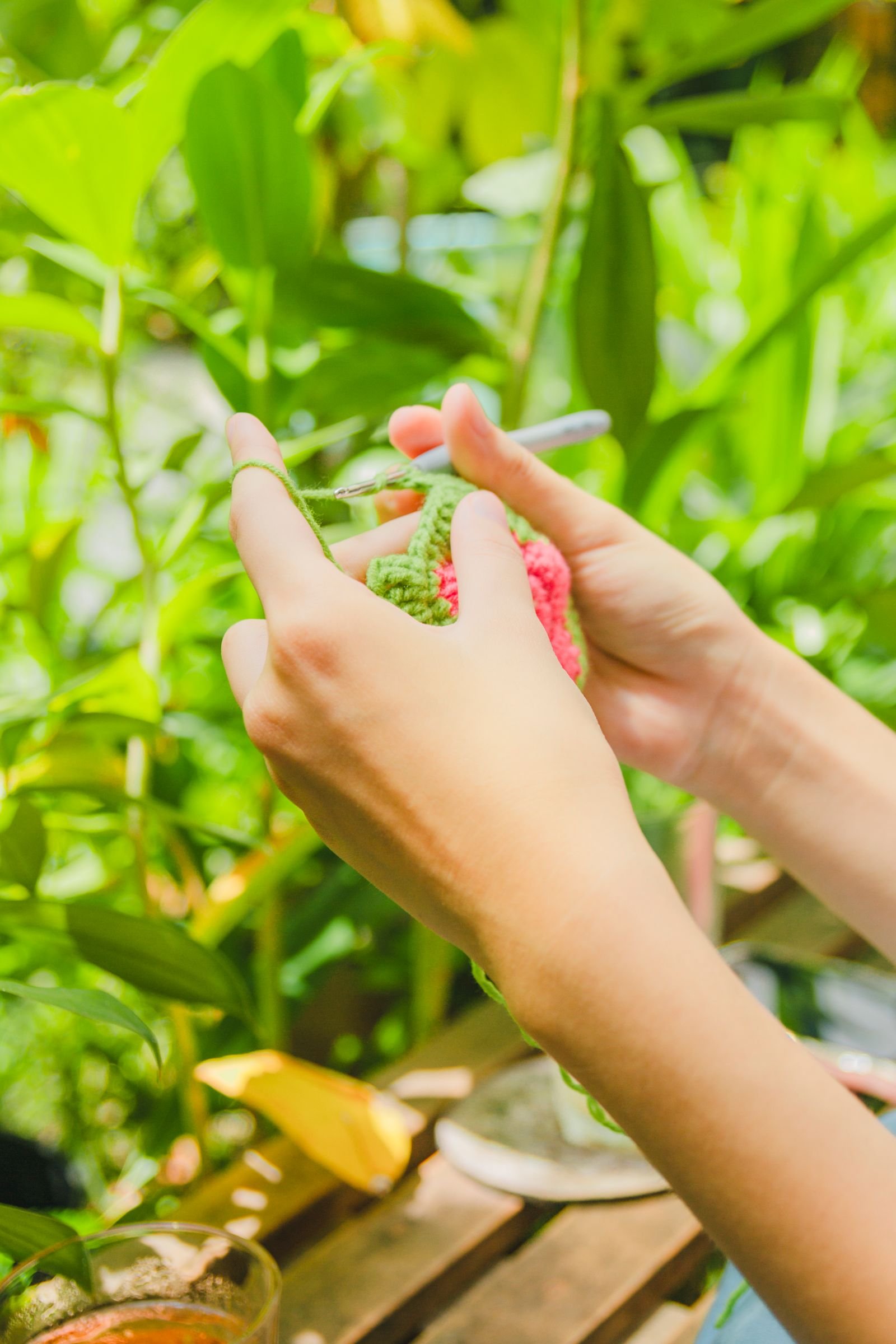 Close-up of a woman crocheting outdoors